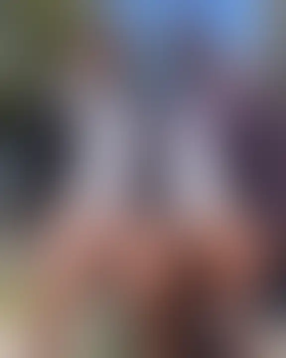 Muscular officer in blue uniform taking a mirror selfie with pants undone and direct gaze under bright lighting