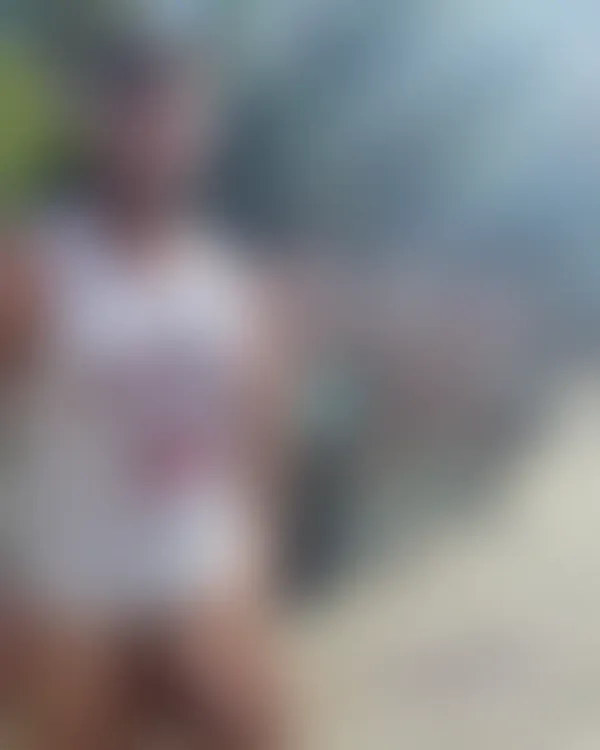 A muscular man in an Ohio State jersey stands confidently poolside under swaying palm trees with a sun-drenched tropical