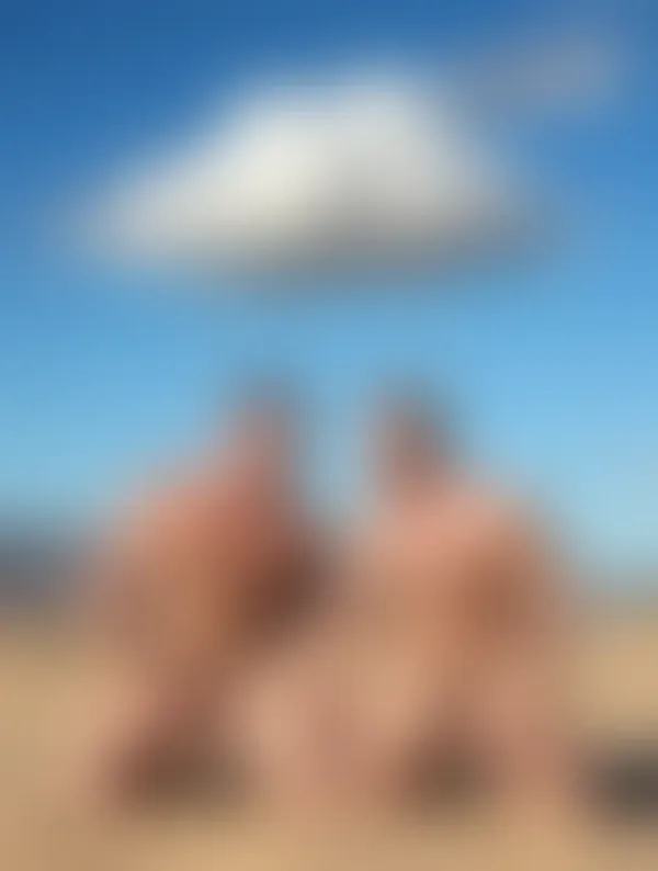 Three shirtless muscular men standing confidently in sunlit water under a clear blue sky, radiating relaxed intimacy and