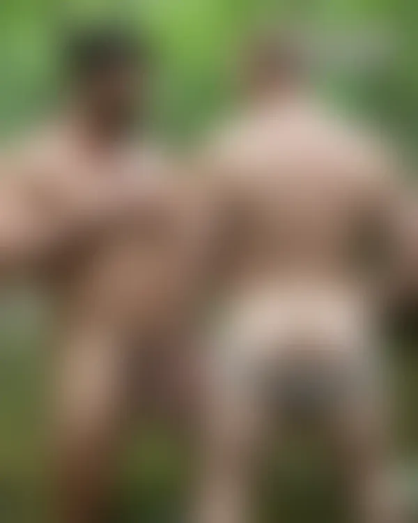 Muscular men in forest stream with dappled light; one hand over chest, intense gaze, lush greenery background